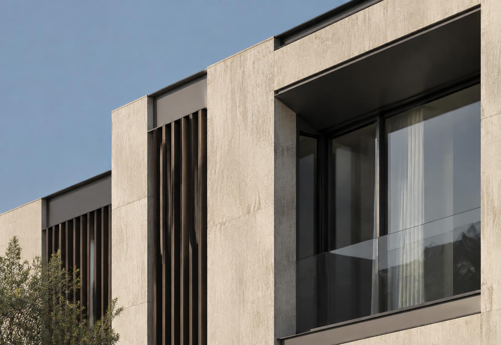 Stone-clad facade detail with bronze fins
